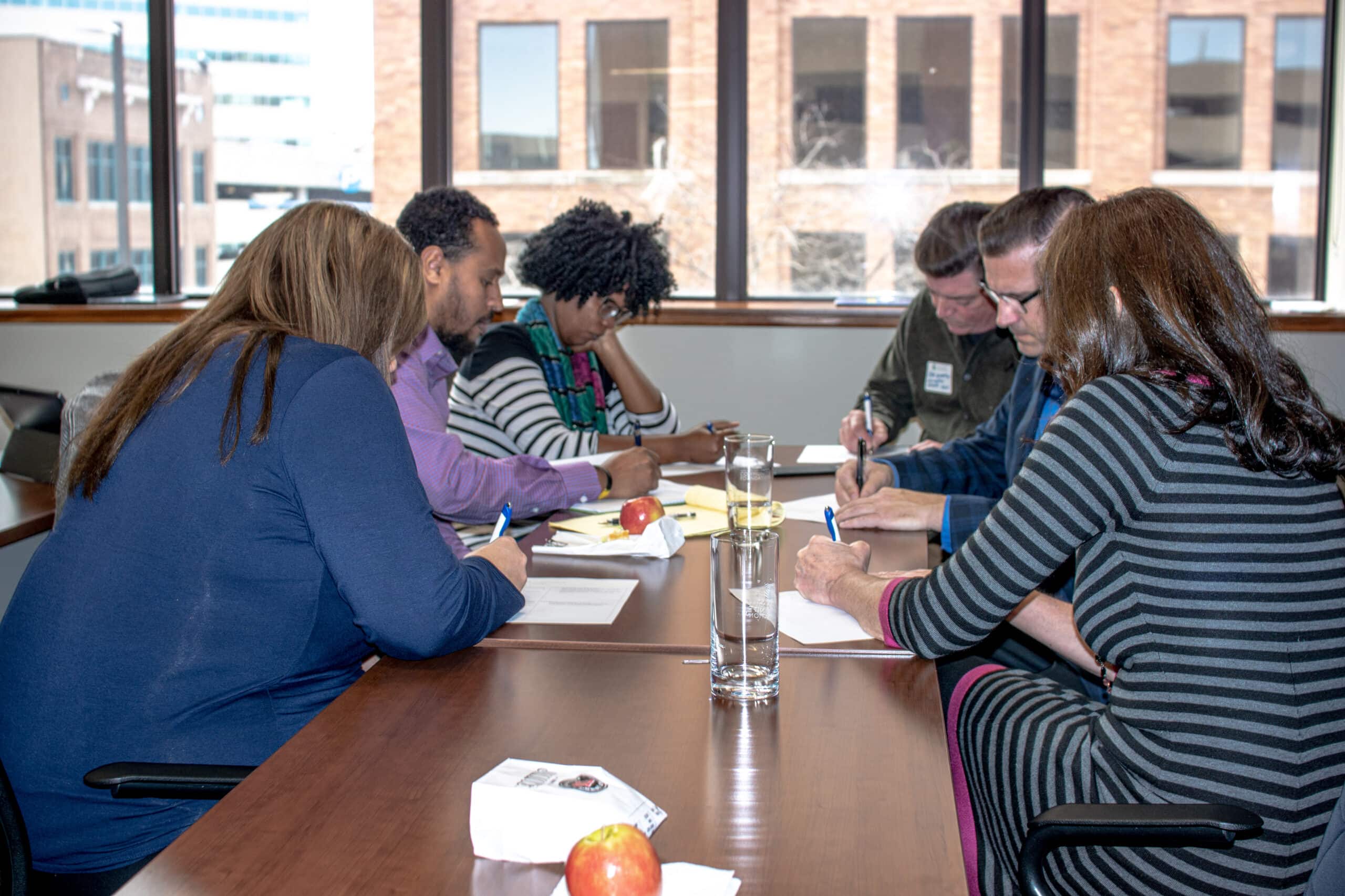 Photo of people collaborating around a table.