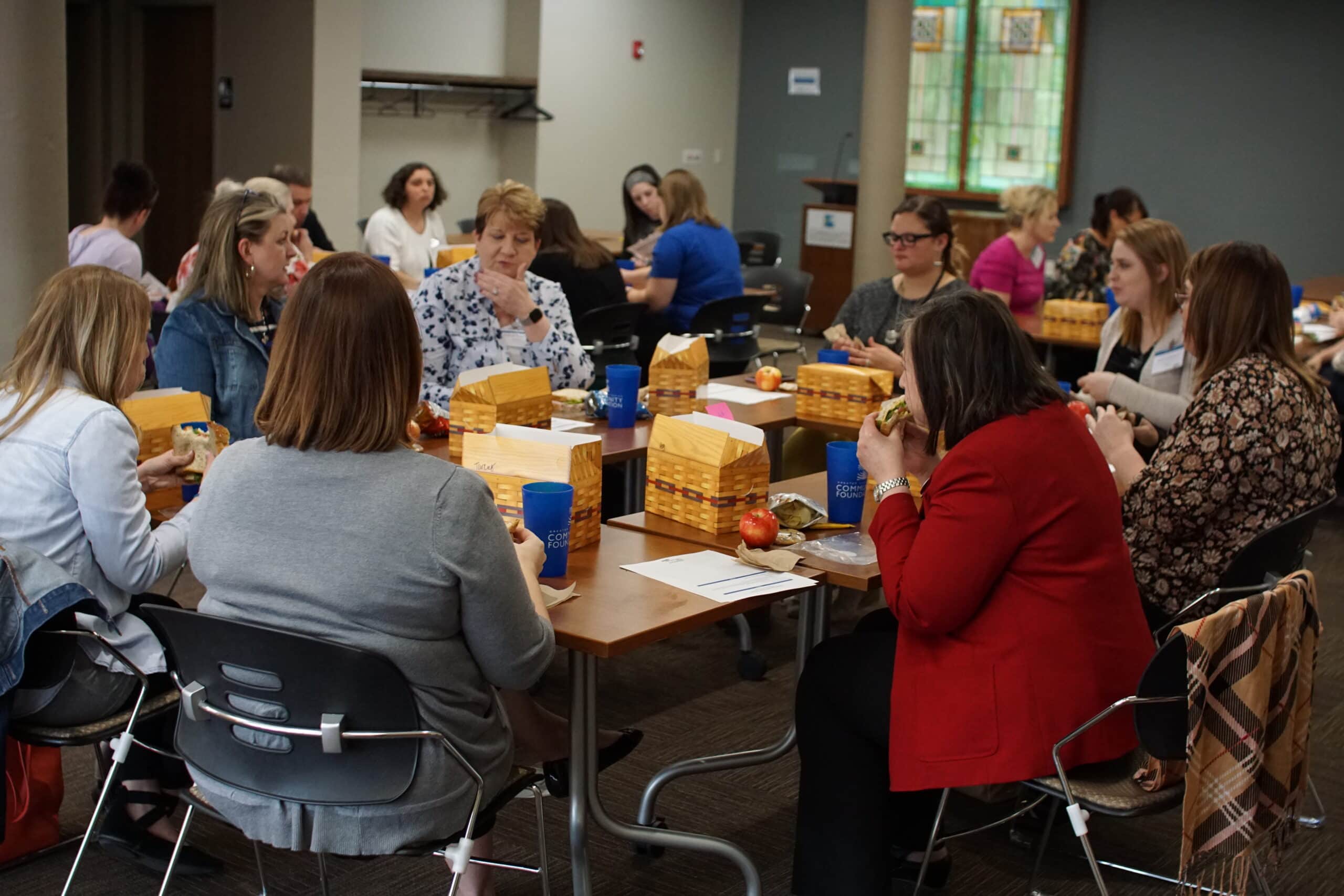Photo of nonprofit professionals having a discussion over lunch at a Nonprofit Peer Group.