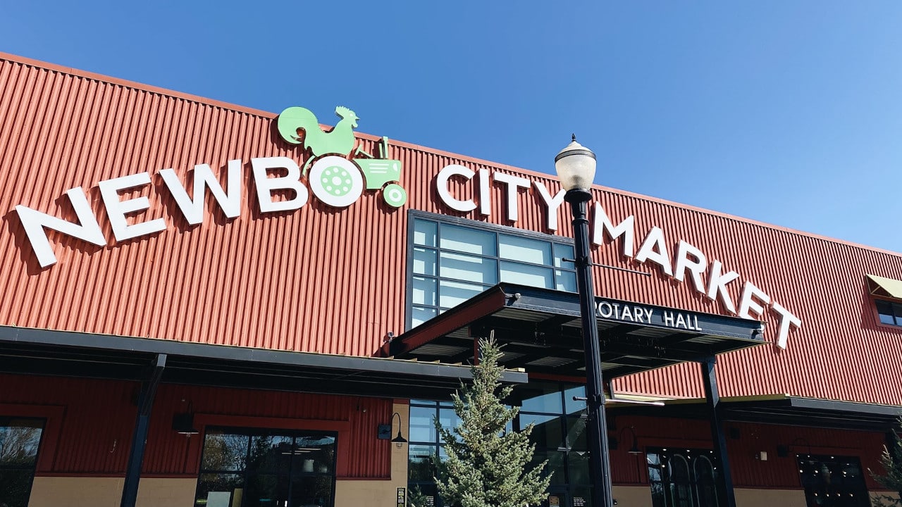 An outdoor view of NewBo City Market, an industrial-looking building converted into a community market.